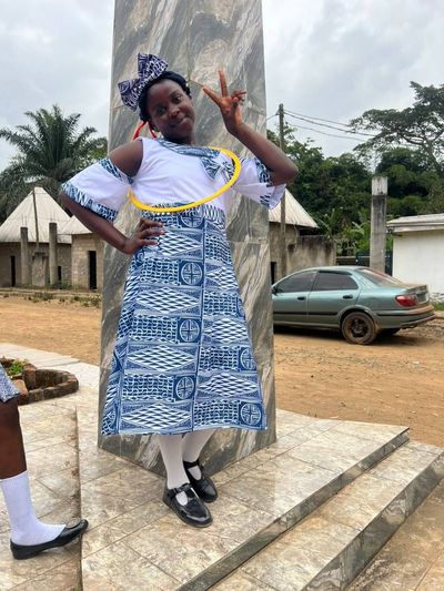 A student wearing the blue-and-white patterned day uniform
